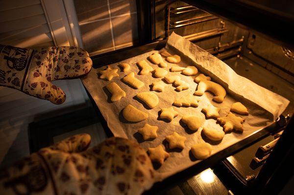 Ein Backblech voller Kekse wird aus dem Ofen genommen.